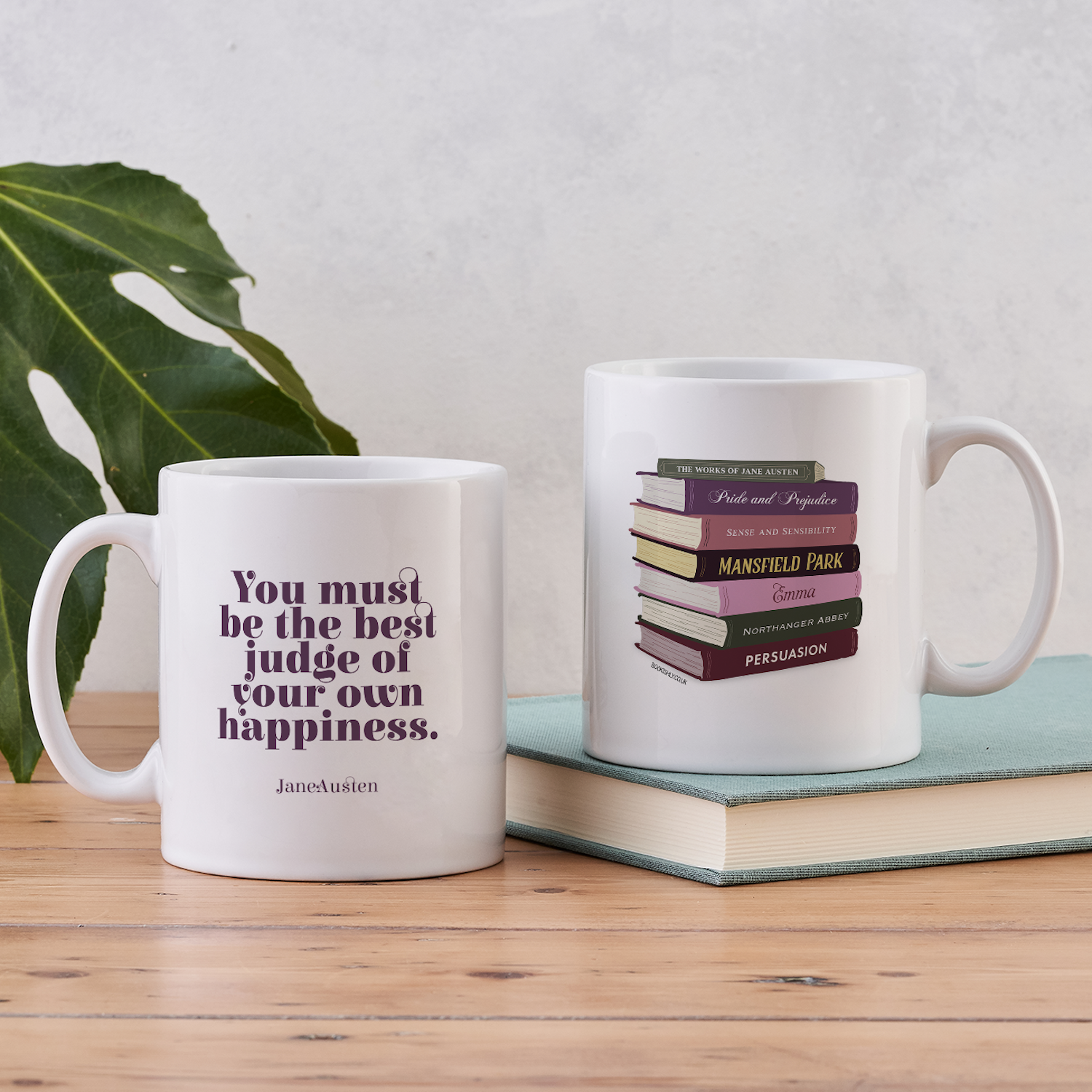 Two-sided Jane Austen mug showing a book stack illustration and the quote “You must be the best judge of your own happiness”