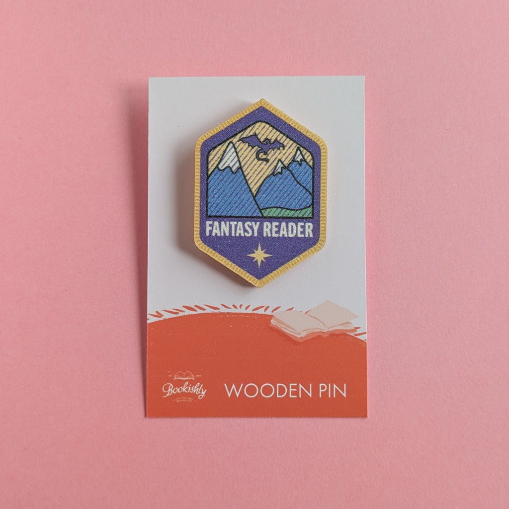 Fantasy Reader wooden merit badge pin on backing card with pink background