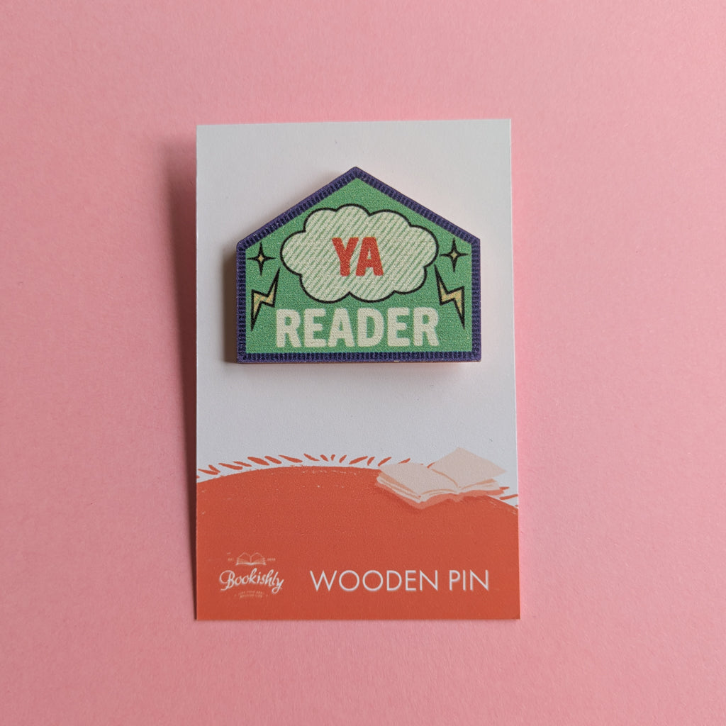YA Reader wooden merit badge pin on backing card with pink background