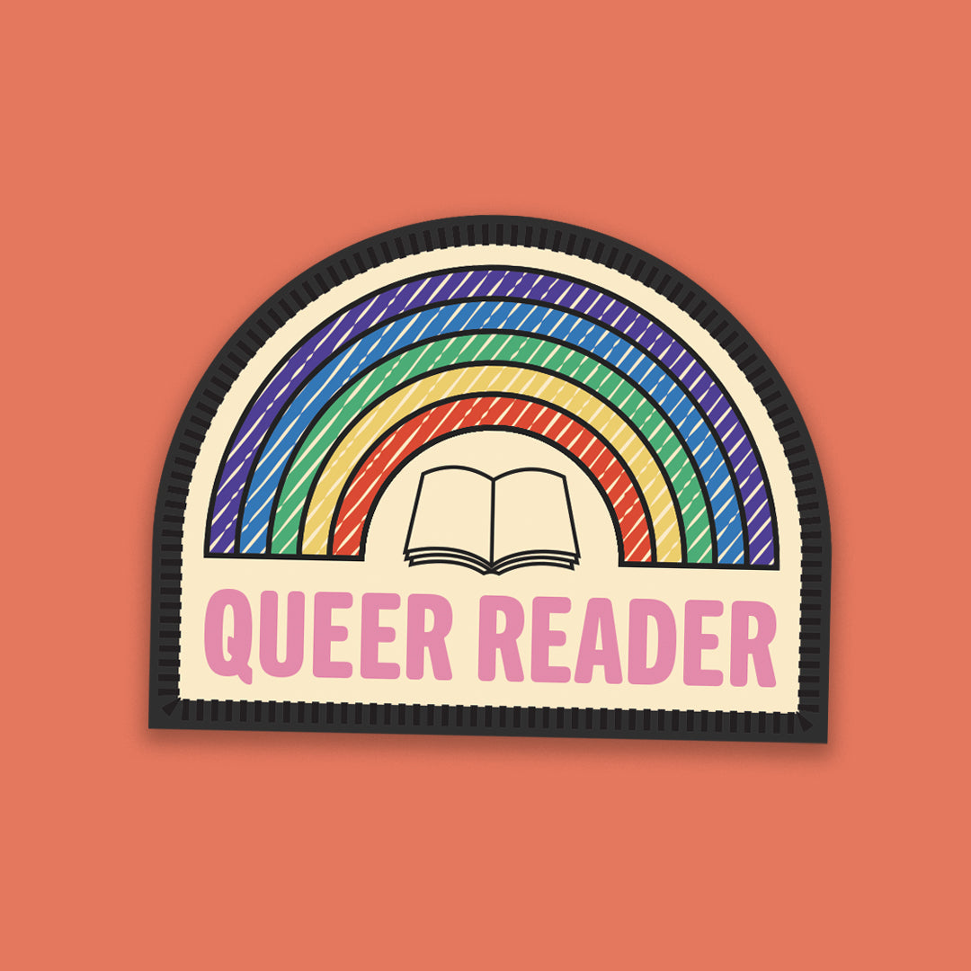 Rainbow-themed “Queer Reader” sticker designed like a woven merit badge, featuring an open book and rainbow background.