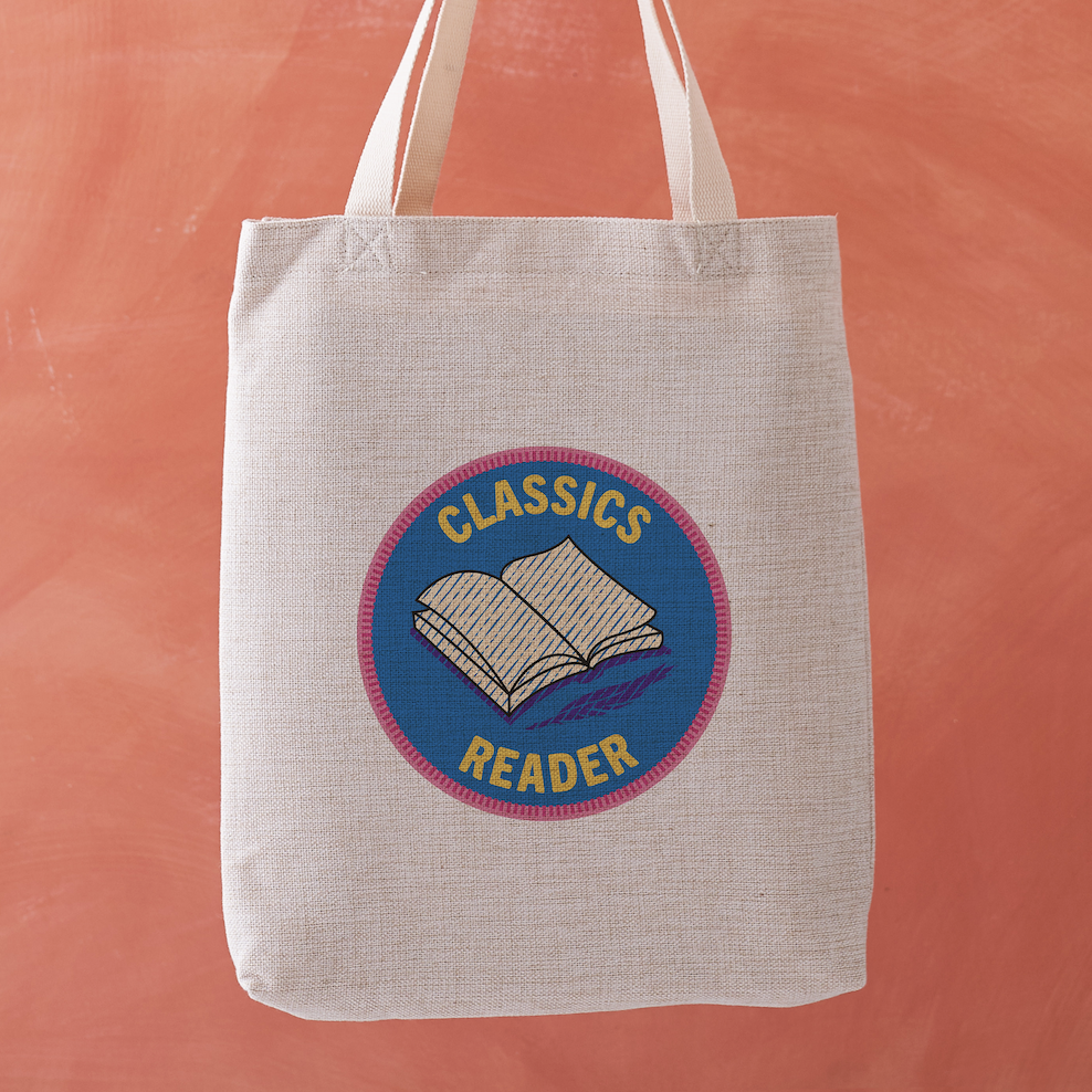 Classics Reader tote bag with a stitched badge-style design in blue, featuring an open book illustration and retro typography.
