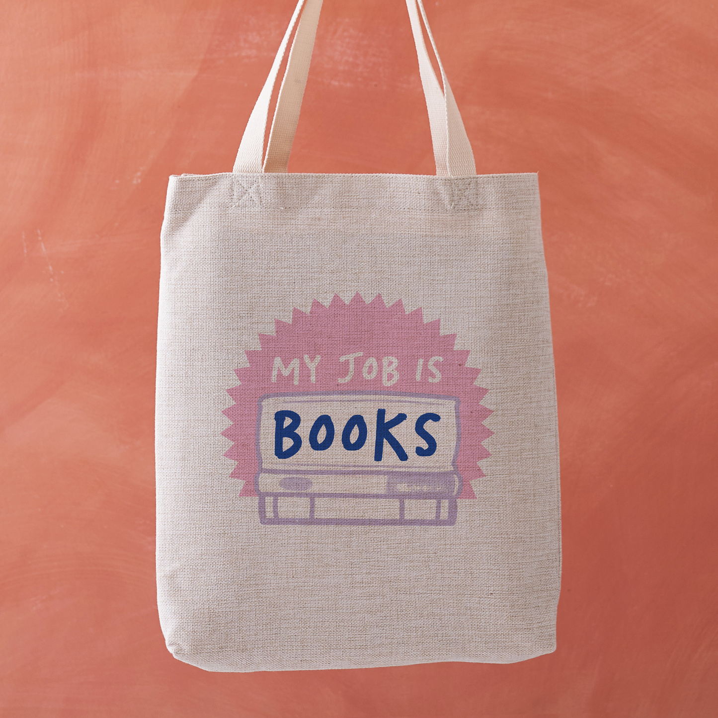 Tote bag with 'My Job is Books' design on an orange background