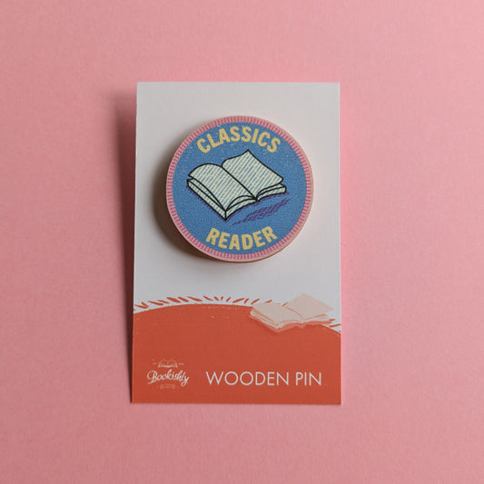 Classics Reader wooden merit badge pin on backing card with pink background