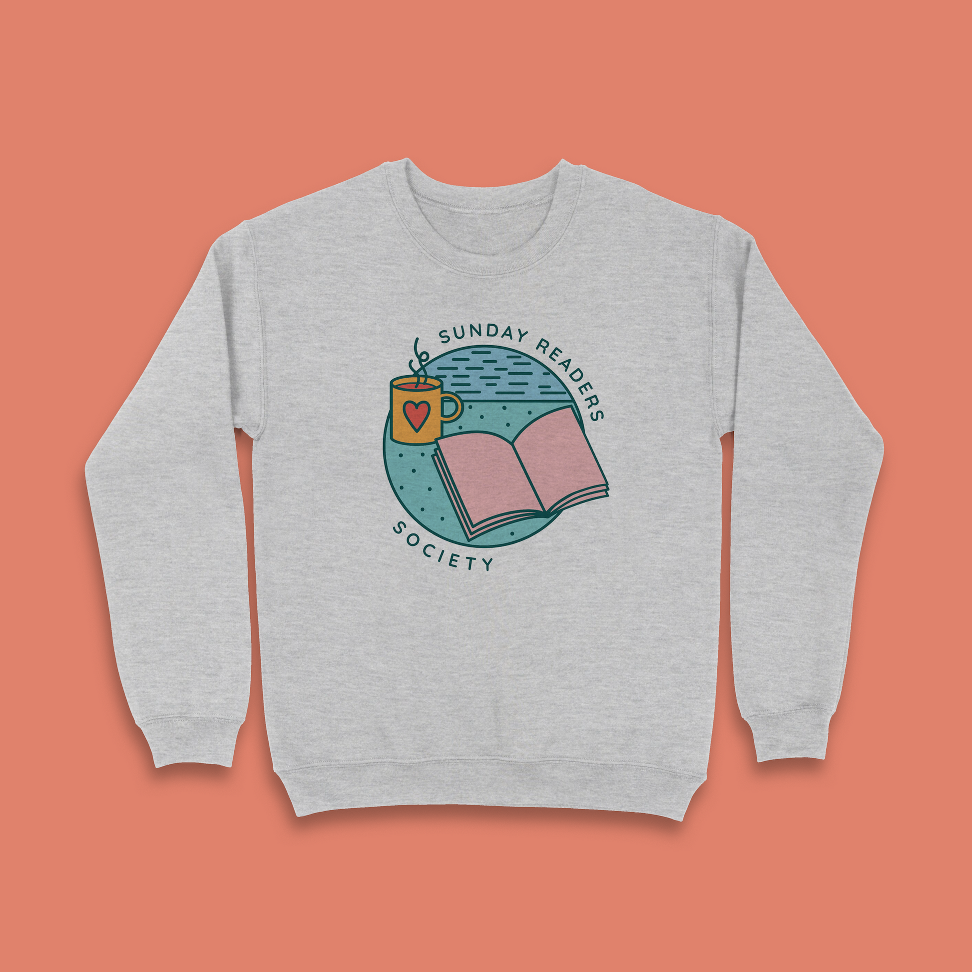 Grey sweatshirt with “Sunday Readers Society” design featuring open book and mug illustration.
