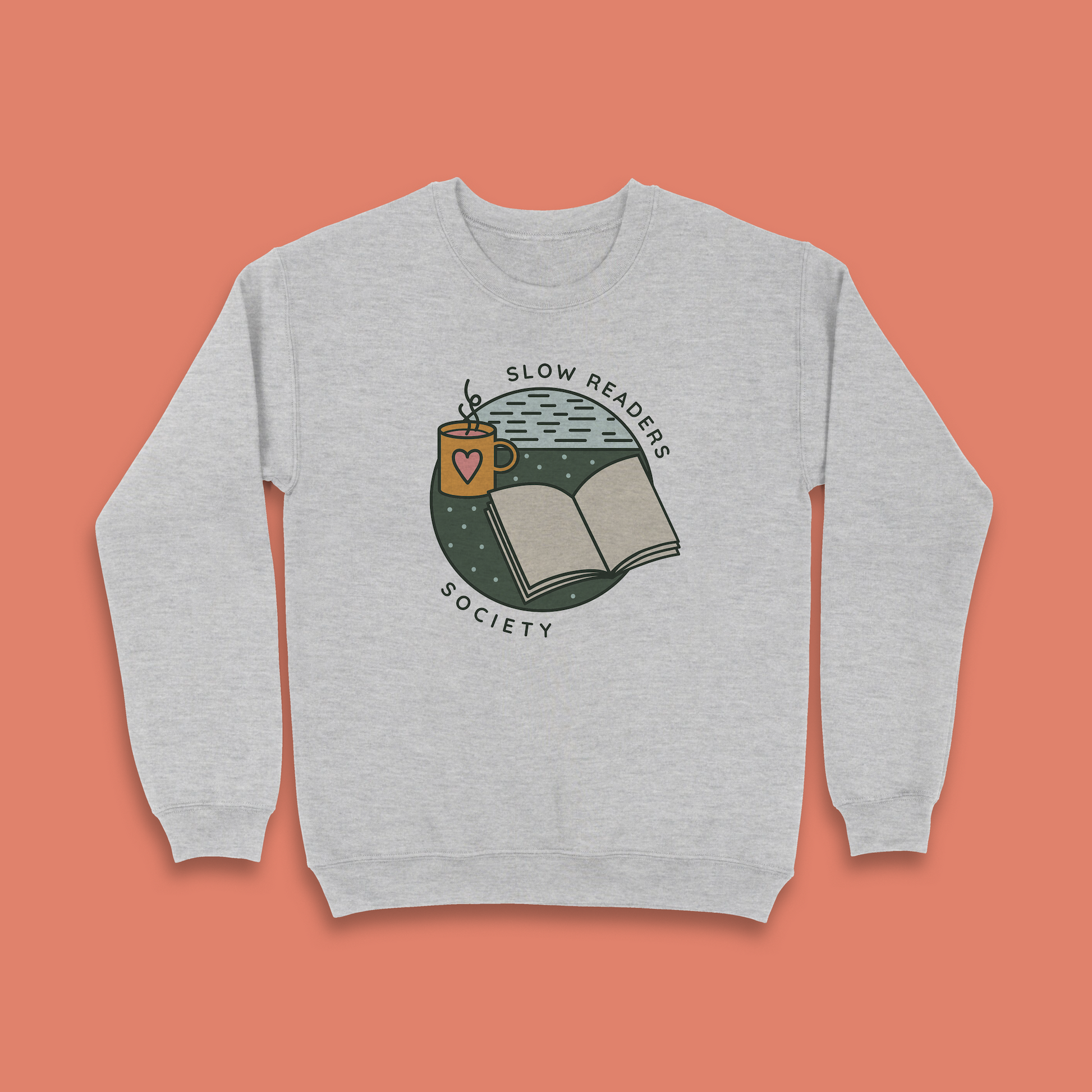 Grey sweatshirt with “Slow Readers Society” design featuring open book and mug illustration.